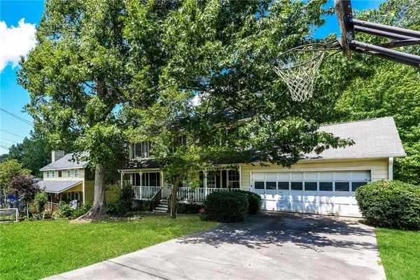 a front view of a house with a garden