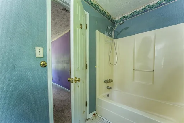 an empty room with windows and ceiling fan view