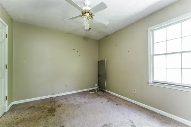 a bathroom with a granite countertop toilet a sink and a mirror