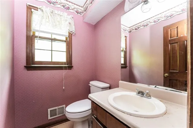 a view of a room with wooden floor and windows