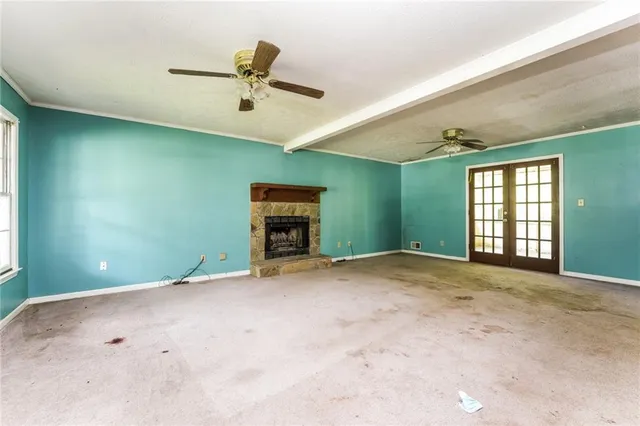 a view of a livingroom with a window and a chandelier