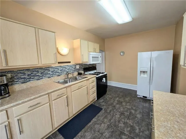 a bathroom with a sink a mirror a bathtub and shower