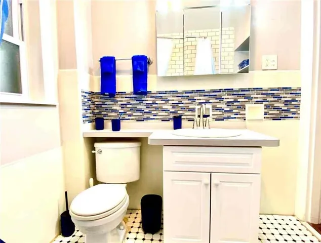 a bathroom with a sink toilet and mirror