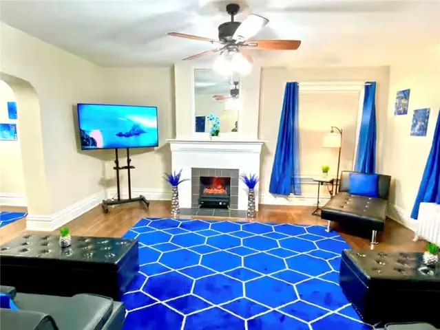 a living room with furniture a fireplace and a flat screen tv