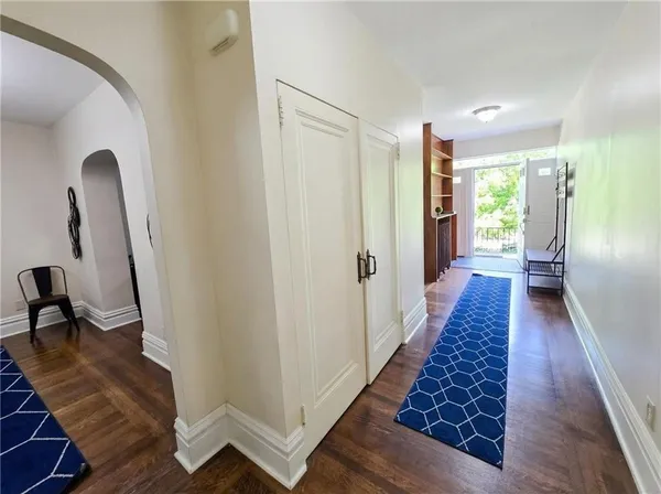 a living room with furniture a rug and a window