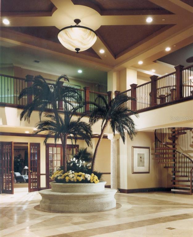 1170 Gulf Boulevard, Unit 1203 Clearwater Beach, FL 33767 - Photo 2 of 34 a view of a lobby with a ceiling fan and windows