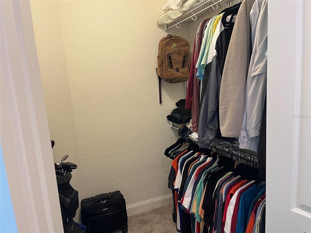 1170 Gulf Boulevard, Unit 1203 Clearwater Beach, FL 33767 - Photo 23 of 34 a view of walk in closet with clothes and shoes