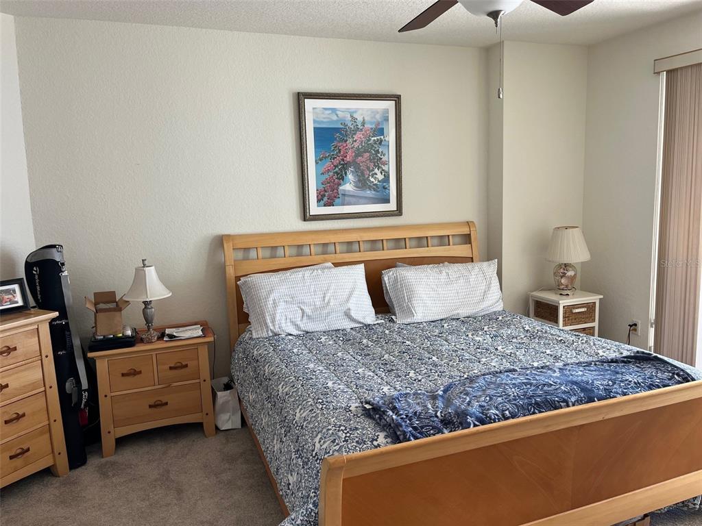 1170 Gulf Boulevard, Unit 1203 Clearwater Beach, FL 33767 - Photo 24 of 34 a bedroom with a bed and furniture