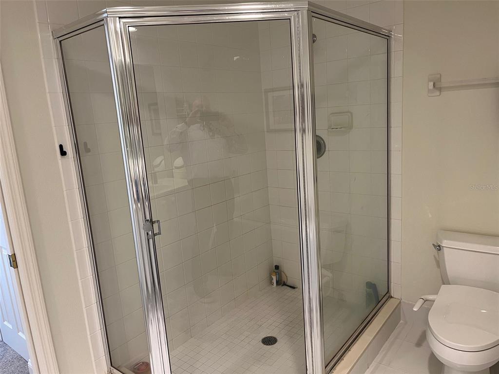 1170 Gulf Boulevard, Unit 1203 Clearwater Beach, FL 33767 - Photo 26 of 34 a bathroom with a shower and toilet