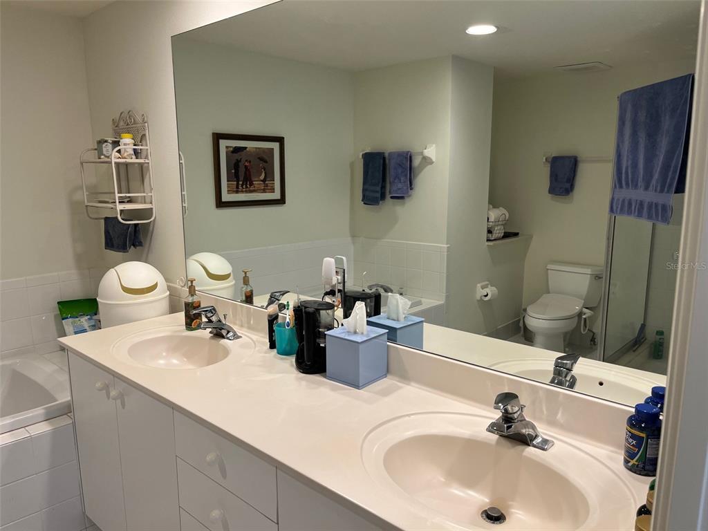 1170 Gulf Boulevard, Unit 1203 Clearwater Beach, FL 33767 - Photo 27 of 34 a bathroom with a sink a toilet and shower