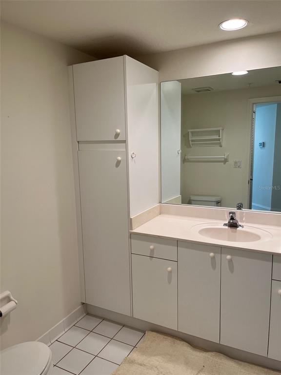 1170 Gulf Boulevard, Unit 1203 Clearwater Beach, FL 33767 - Photo 33 of 34 a bathroom with a sink and mirror