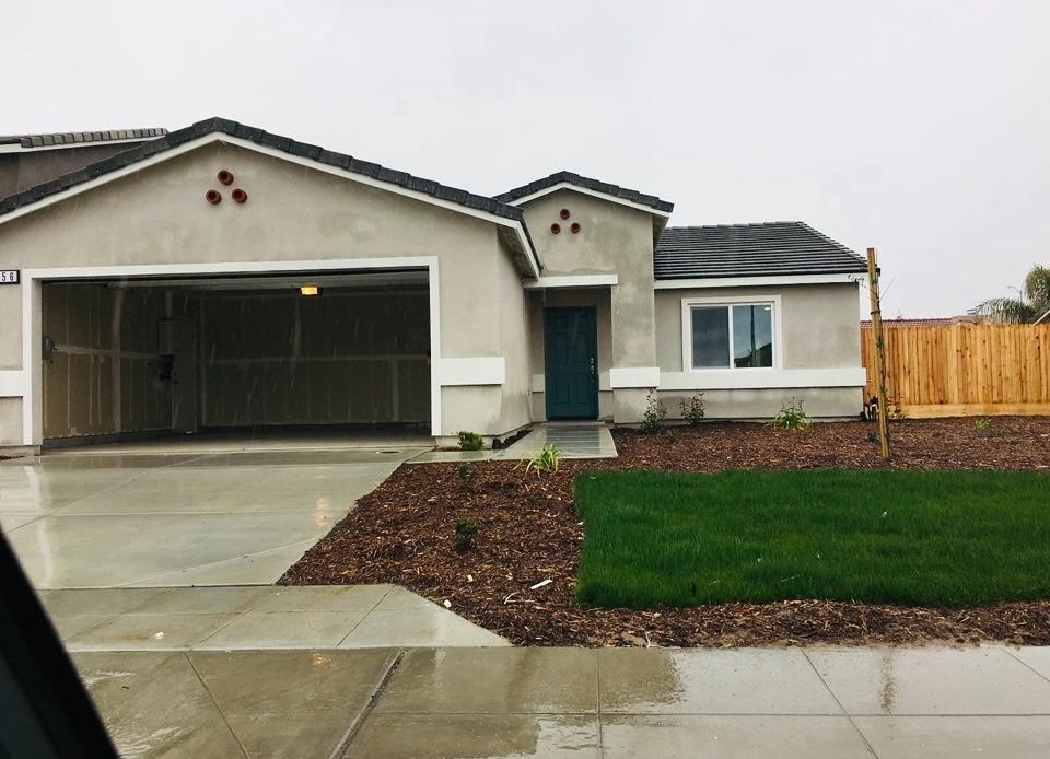 356 Solano Street Madera, CA 93638 - Photo 1 of 15 a front view of a house with a yard and garage