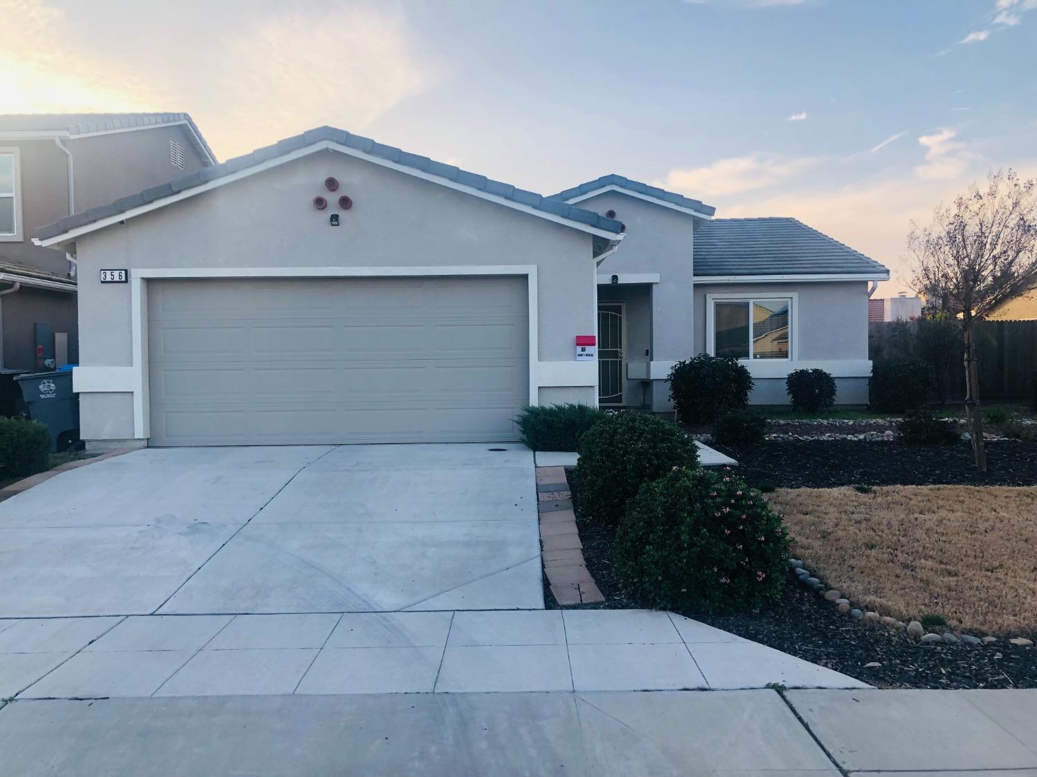 356 Solano Street Madera, CA 93638 - Photo 2 of 15 a front view of house with yard and trees
