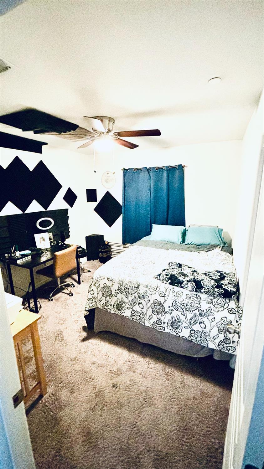 356 Solano Street Madera, CA 93638 - Photo 9 of 15 a bedroom with a bed and a walk in closet