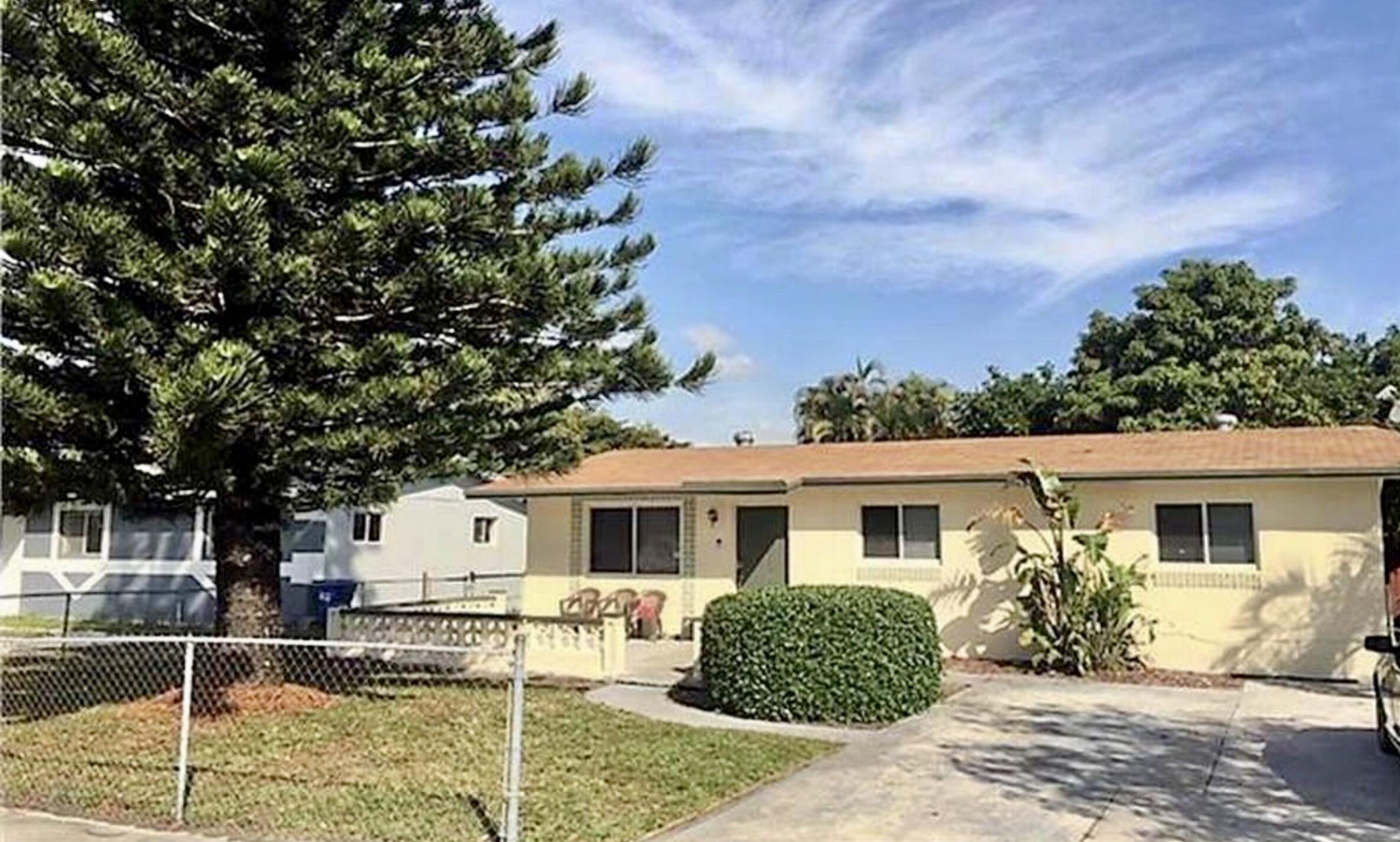 2811 Northwest 8th Street Pompano Beach, FL 33069 - Photo 2 of 7 a front view of a house with garden