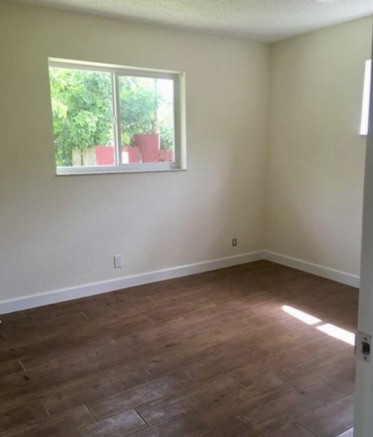 2811 Northwest 8th Street Pompano Beach, FL 33069 - Photo 7 of 7 an empty room with a window