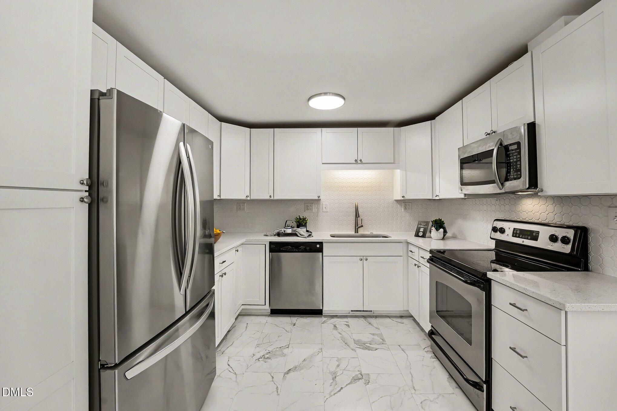 2125 Cheek Road Durham, NC 27704 - Photo 11 of 24 a kitchen with stainless steel appliances granite countertop a refrigerator sink and stove