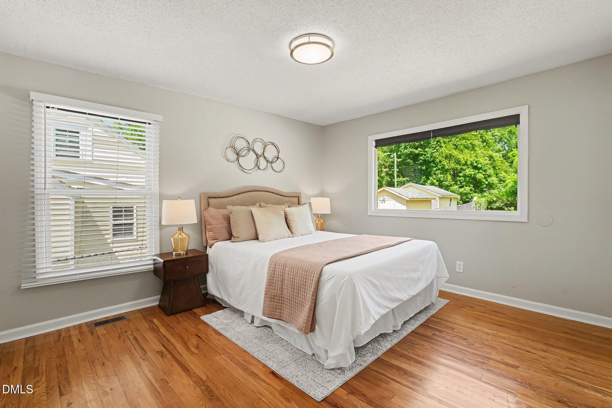 2125 Cheek Road Durham, NC 27704 - Photo 14 of 24 a bedroom with a large bed and a window