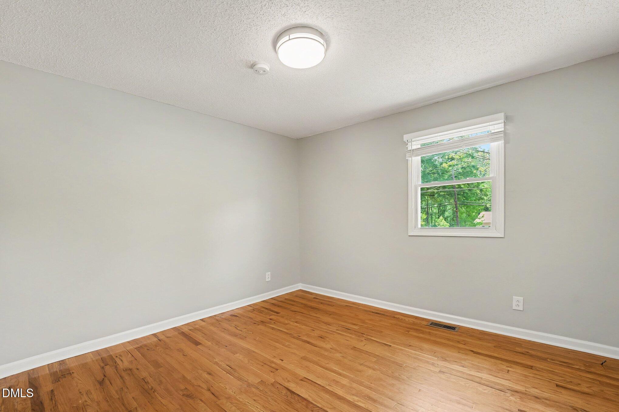2125 Cheek Road Durham, NC 27704 - Photo 19 of 24 an empty room with a window