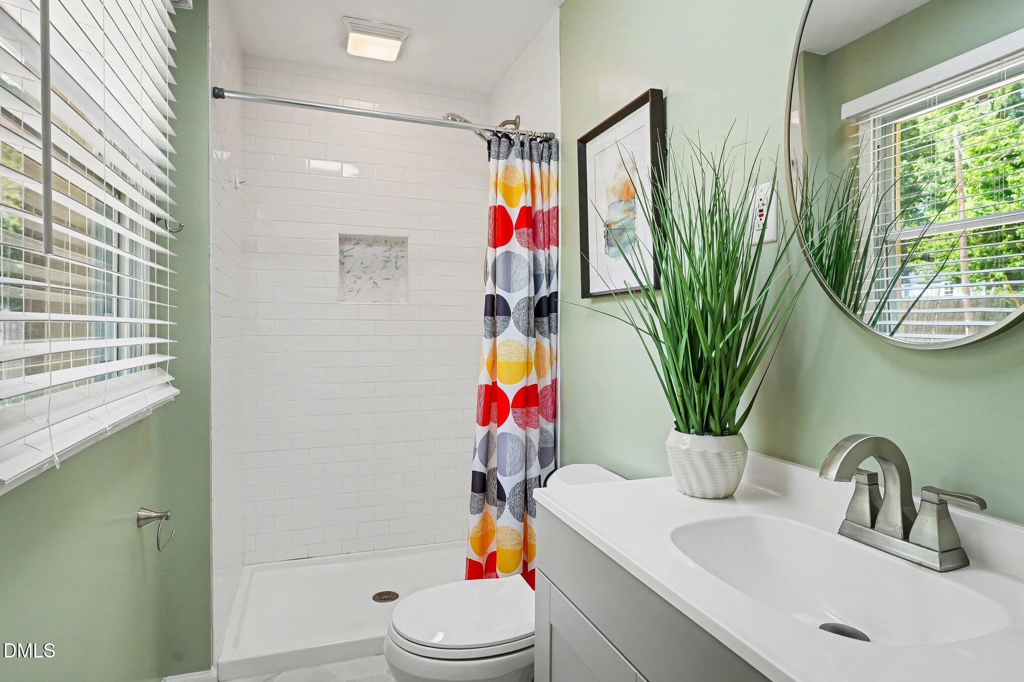 2125 Cheek Road Durham, NC 27704 - Photo 20 of 24 a bathroom with a sink toilet and mirror