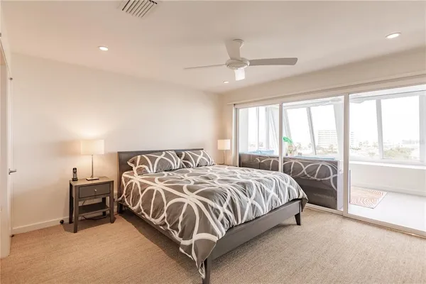 a bedroom with a bed and a large window