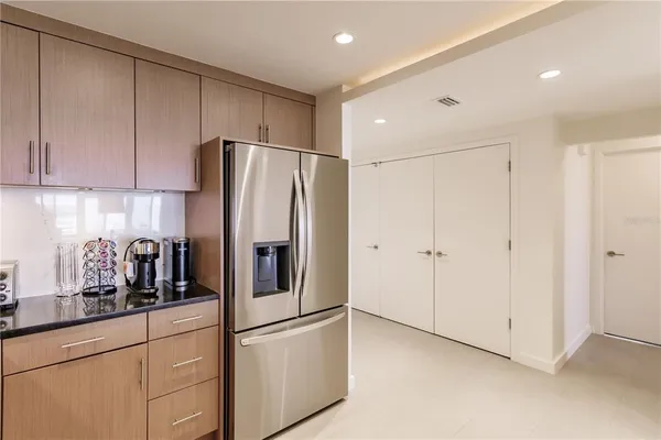 a kitchen with stainless steel appliances white cabinets and a refrigerator