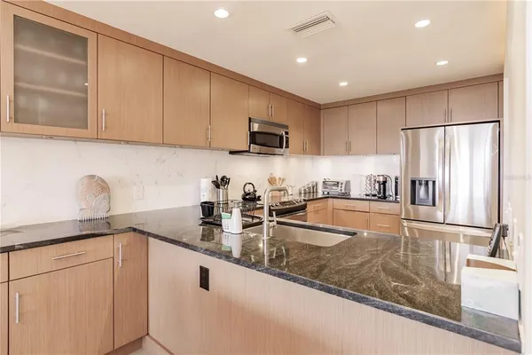 a kitchen with refrigerator and cabinets