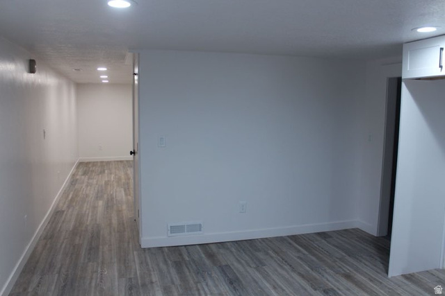 545 100 East Bountiful, UT 84010 - Photo 9 of 17 Spare room featuring recessed lighting and dark wood-style floors