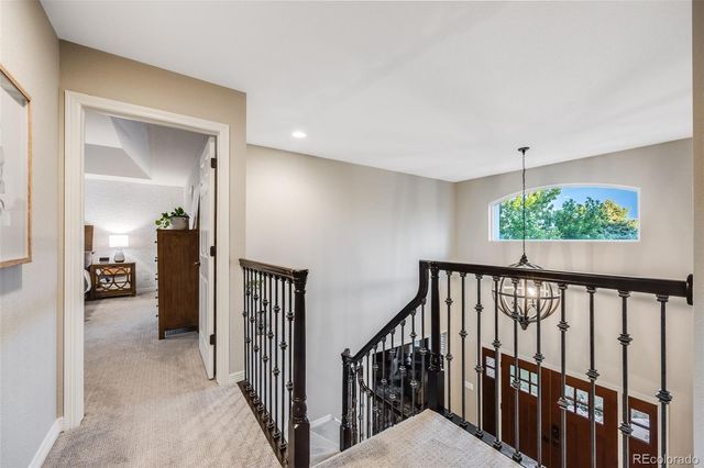 a view of a hallway to a livingroom with furniture