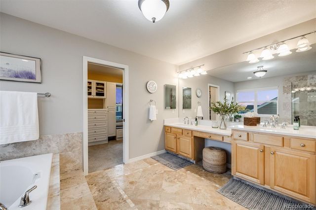 a large white kitchen with a sink and cabinets