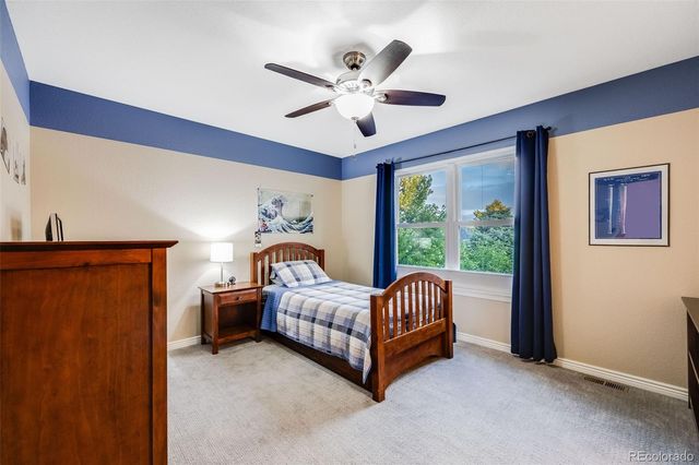 a living room with a bed and a chandelier