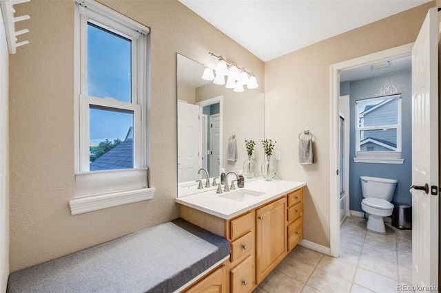 a bathroom with a sink double vanity and a toilet
