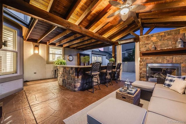 a living room with furniture a fireplace and a table
