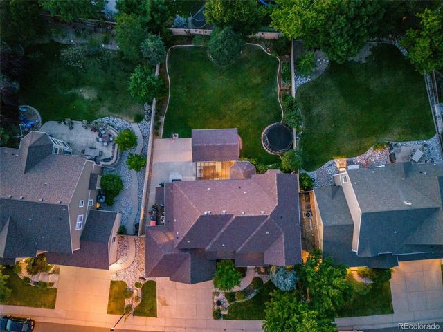 an aerial view of a house with garden space and street view