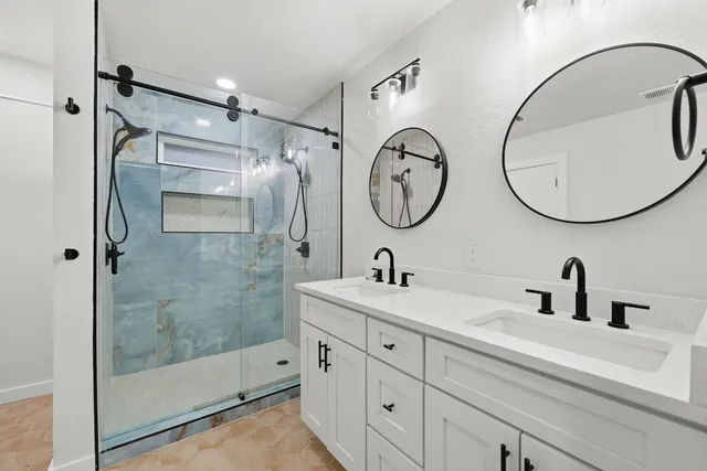 a bathroom with a mirror sink and a mirror