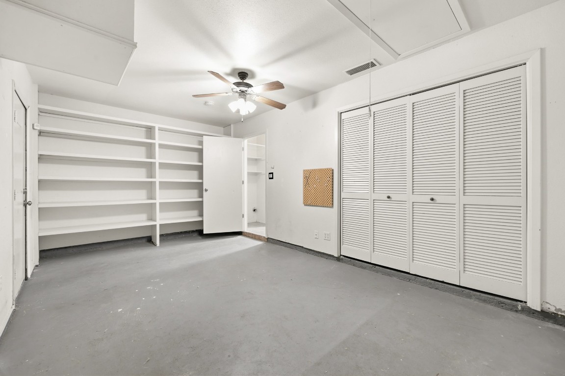 125 Blue Ridge Trail Elgin, TX 78621 - Photo 14 of 27 Garage enclosure with attic access, unfinished concrete floors, ceiling fan, and a closet