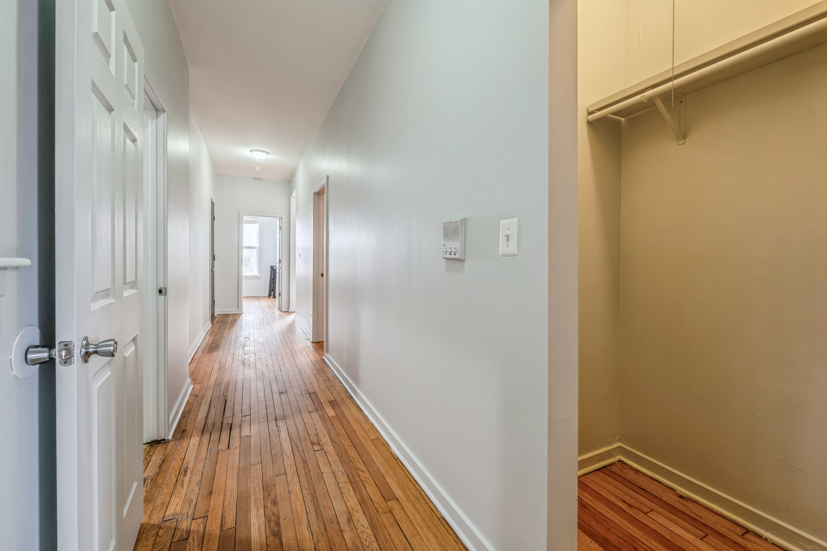 308 North Kedzie Avenue, Unit 1 Chicago, IL 60624 - Photo 5 of 11 a view of a hallway with wooden floor and a bathroom