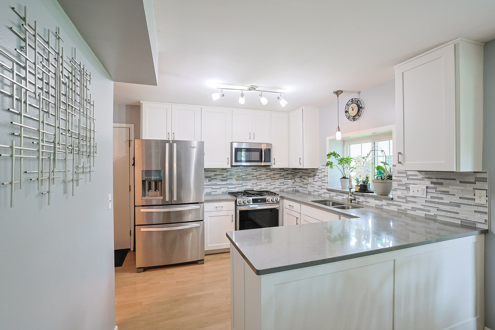 830 Hawk Lane Carol Stream, IL 60188 - Photo 6 of 30 a kitchen with kitchen island white cabinets and stainless steel appliances