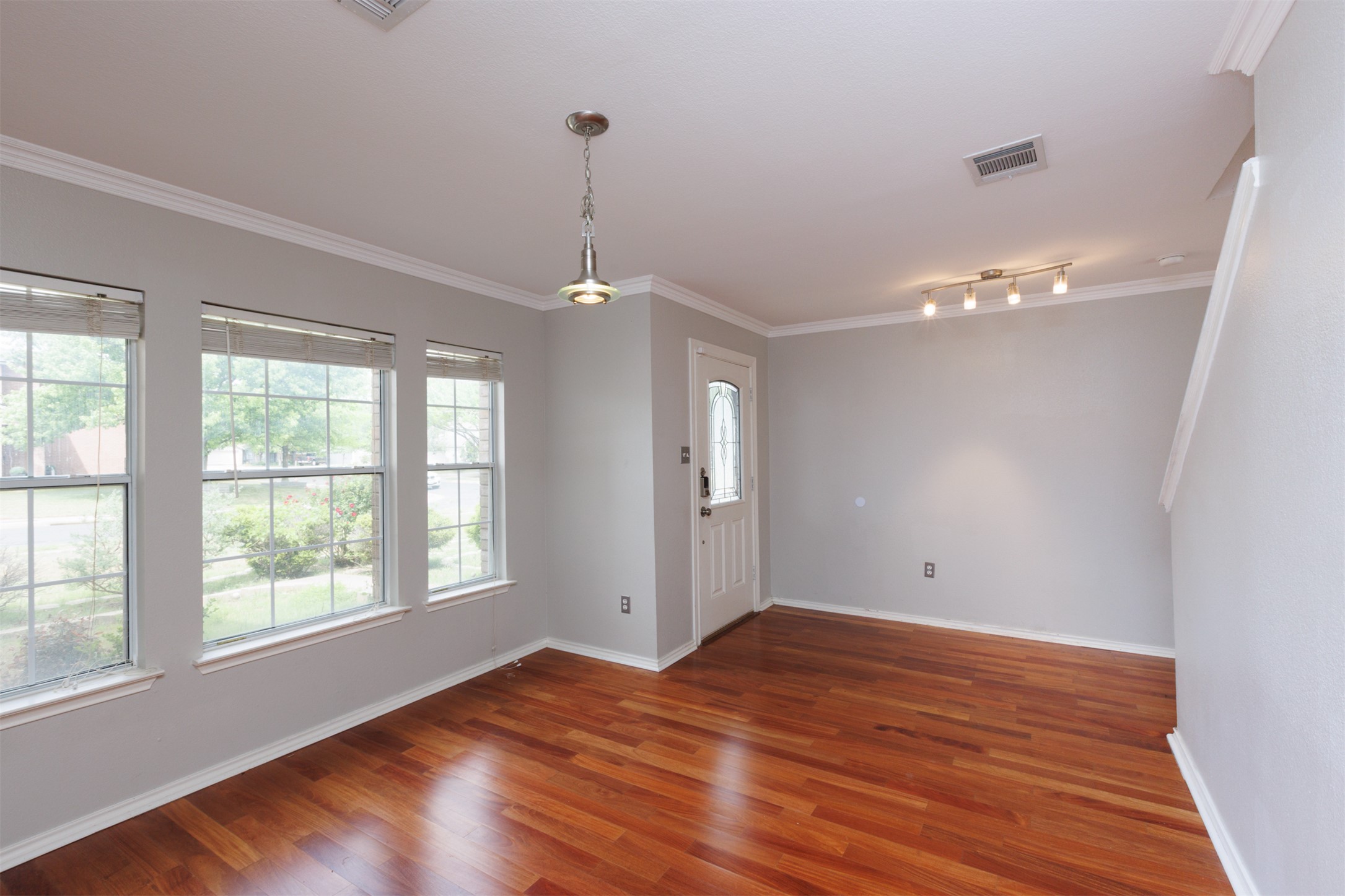 1101 Sheltie Lane Round Rock, TX 78664 - Photo 11 of 22 a view of an empty room with wooden floor and a window