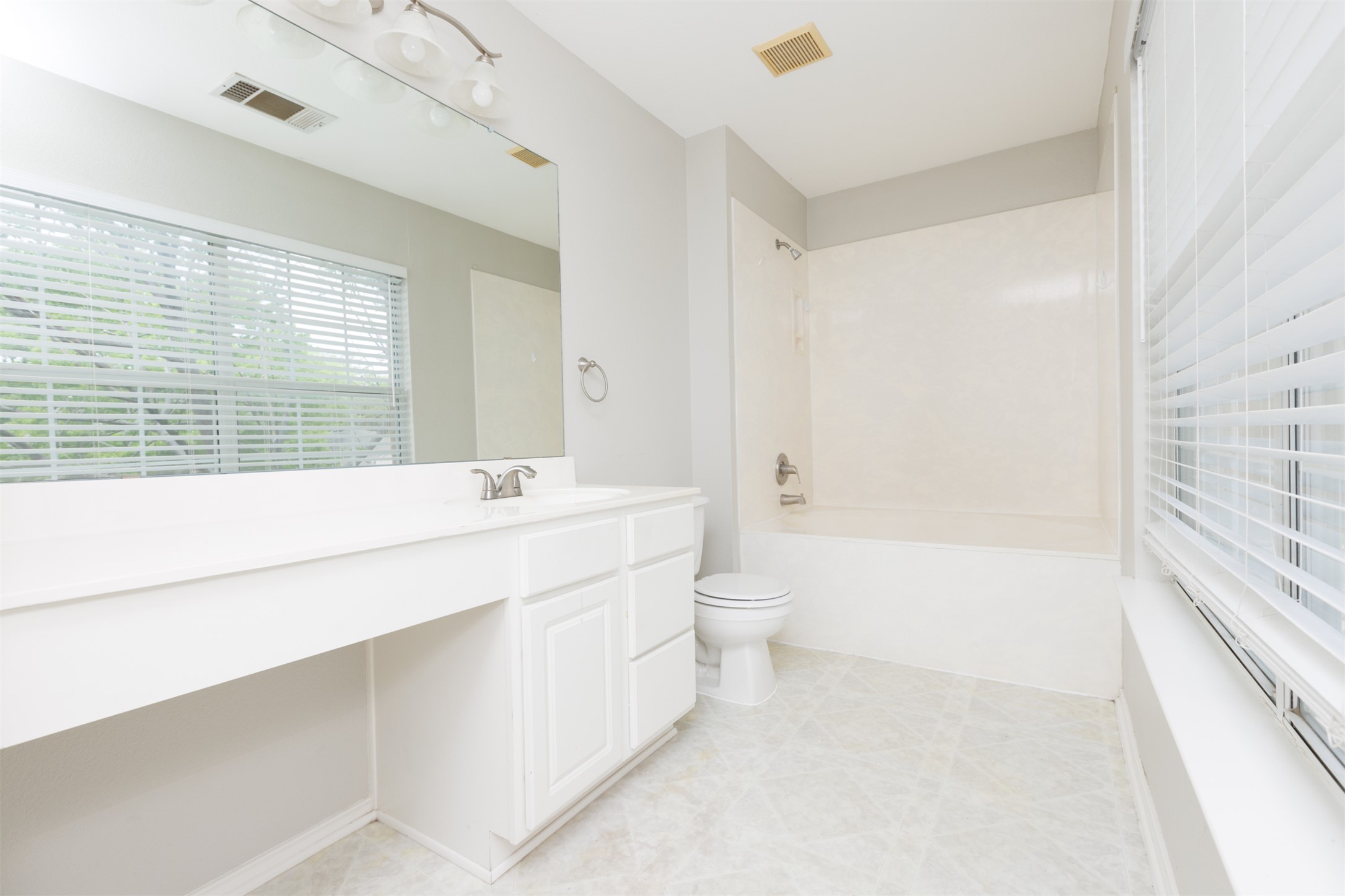 1101 Sheltie Lane Round Rock, TX 78664 - Photo 16 of 22 a bathroom with a bathtub shower sink vanity and toilet