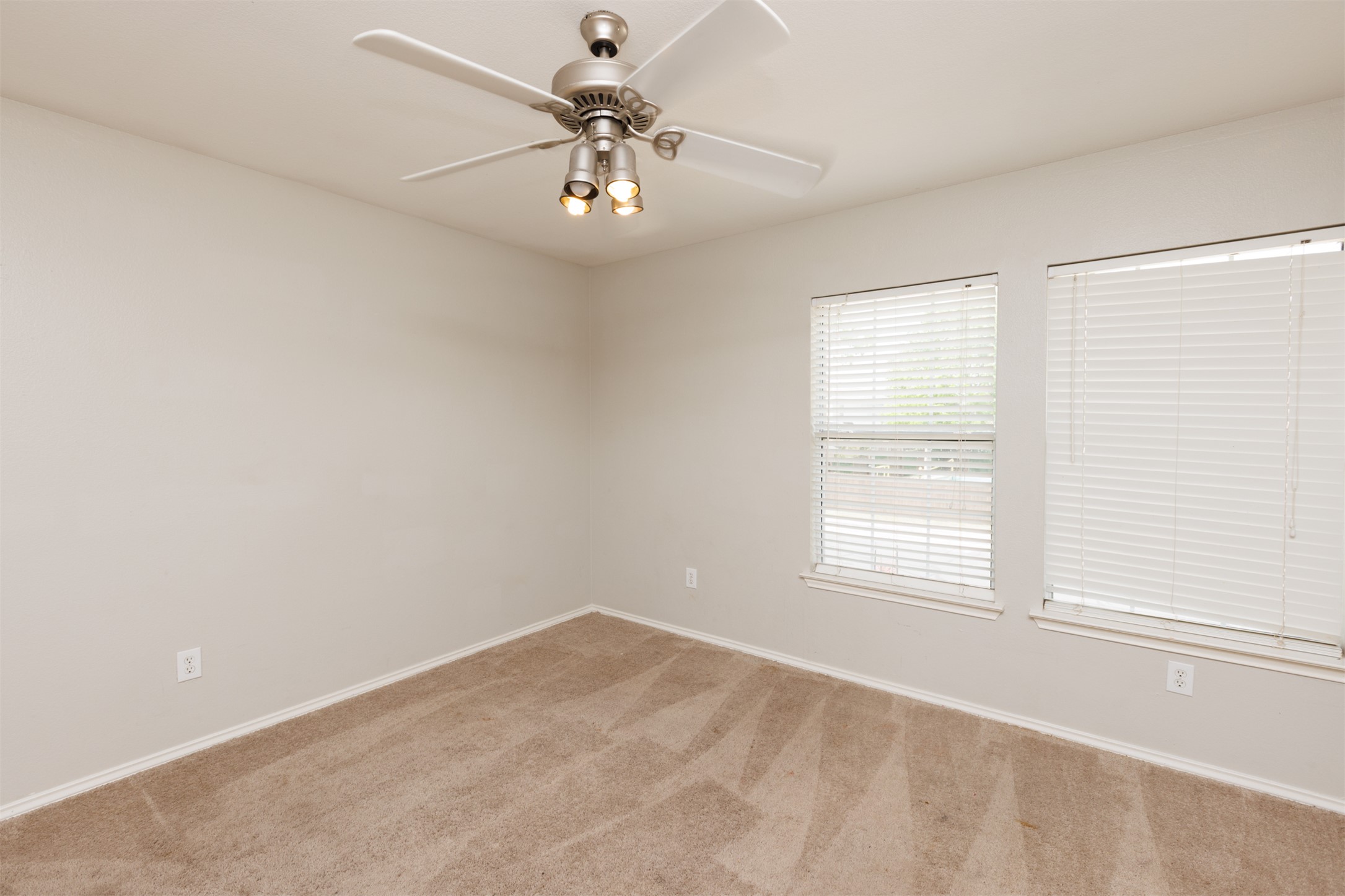 1101 Sheltie Lane Round Rock, TX 78664 - Photo 19 of 22 an empty room with a chandelier fan and windows