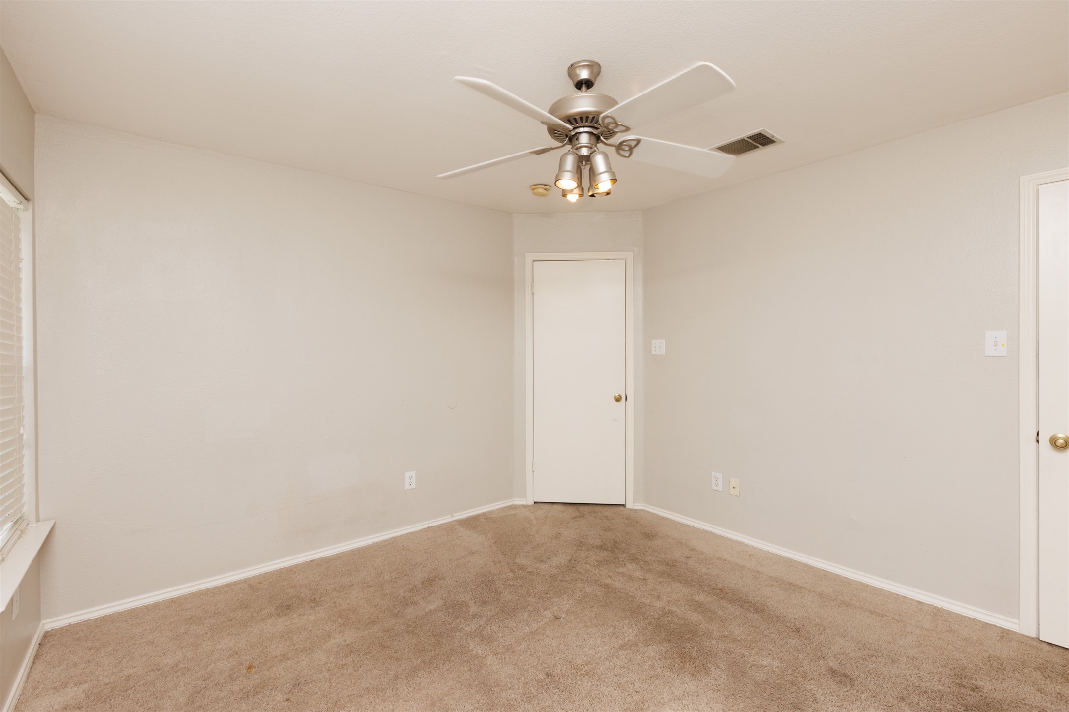 1101 Sheltie Lane Round Rock, TX 78664 - Photo 20 of 22 an empty room with a chandelier fan and windows