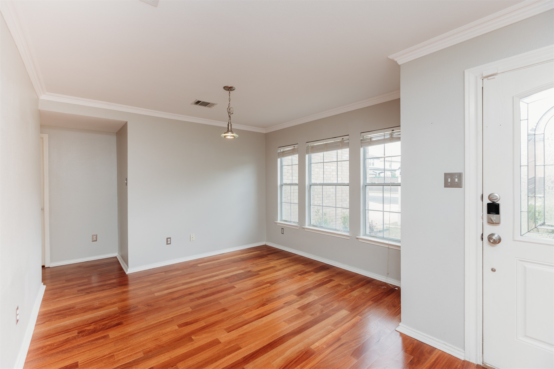 1101 Sheltie Lane Round Rock, TX 78664 - Photo 2 of 22 an empty room with wooden floor and windows
