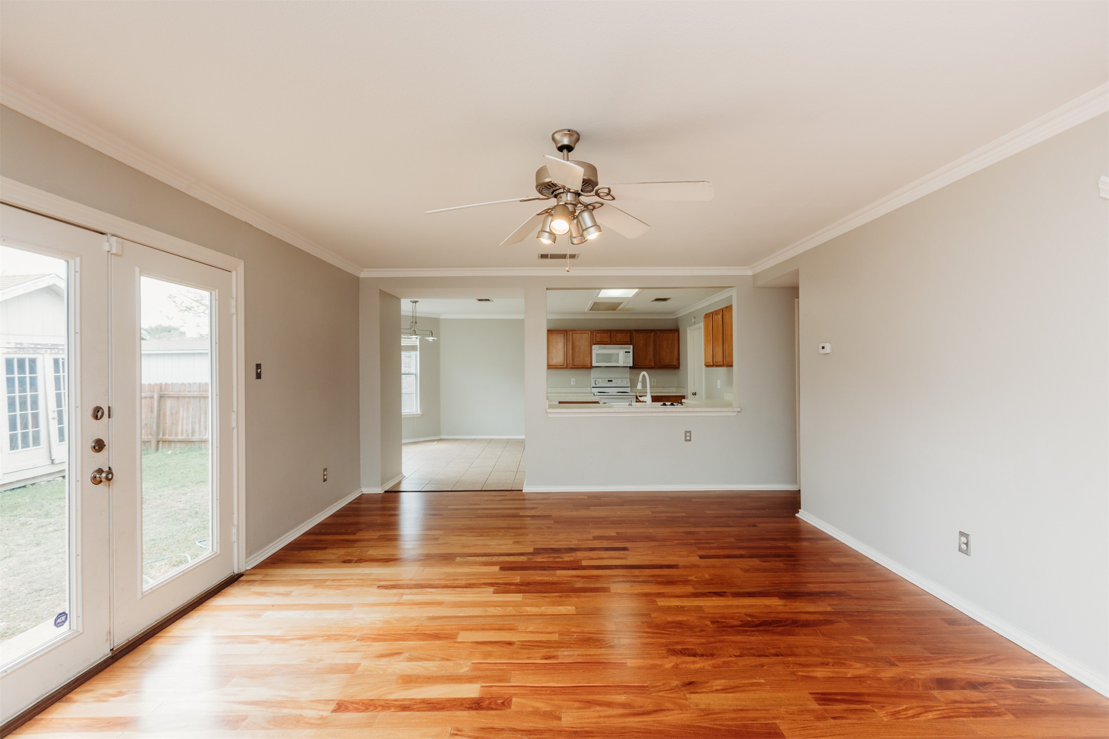 1101 Sheltie Lane Round Rock, TX 78664 - Photo 5 of 22 a view of a room with wooden floor and a ceiling fan