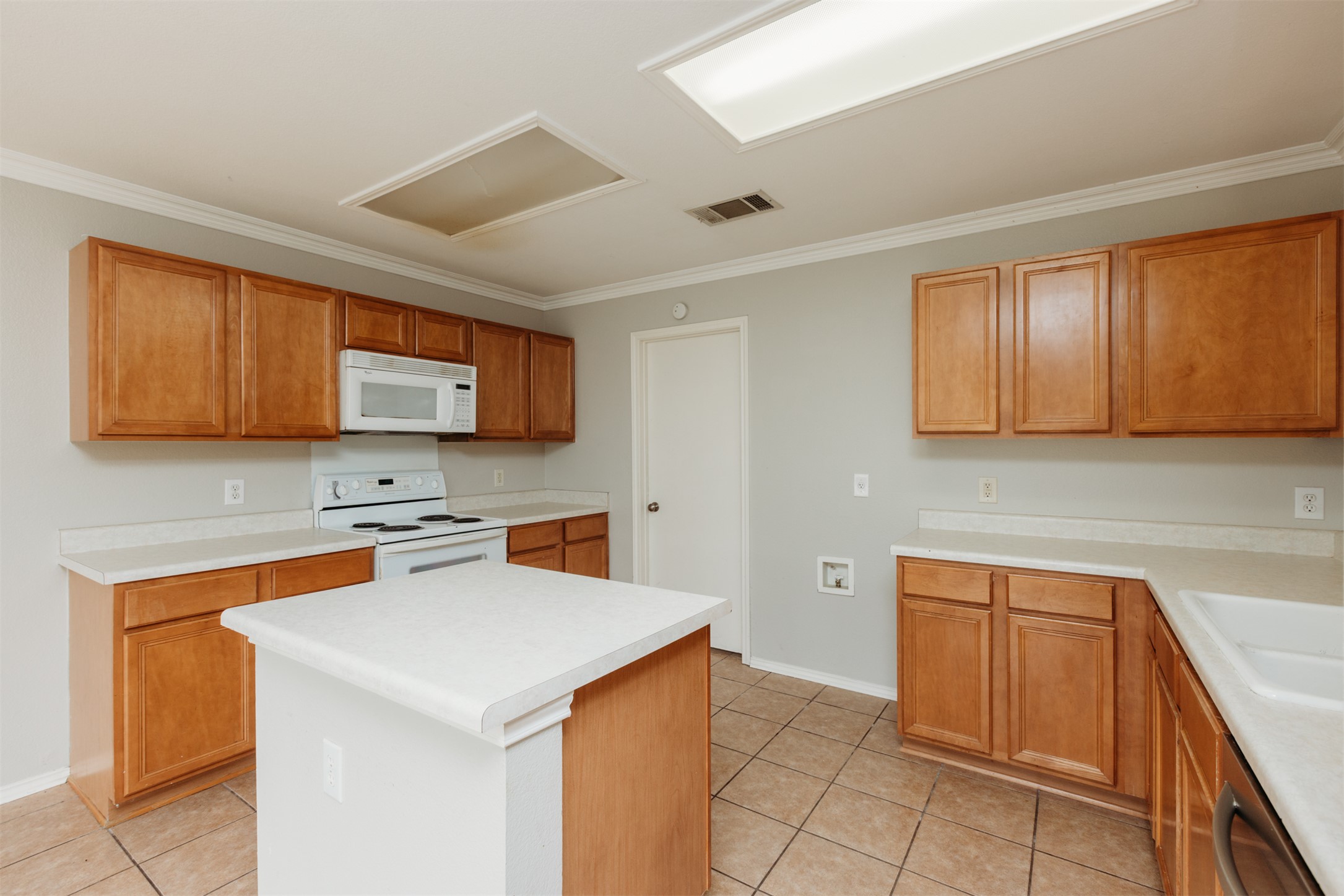 1101 Sheltie Lane Round Rock, TX 78664 - Photo 8 of 22 a kitchen with stainless steel appliances a stove sink microwave and cabinets