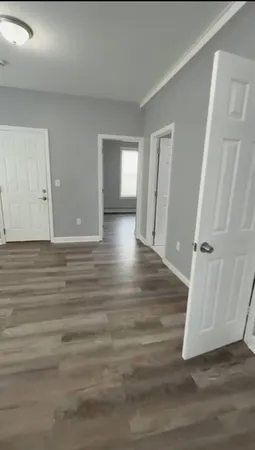 a view of room with window and wooden floor