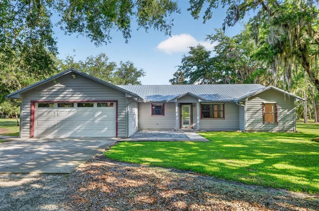 171 William Street Edgewater, FL 32141 - Photo 1 of 40 a front view of a house with a garden and yard
