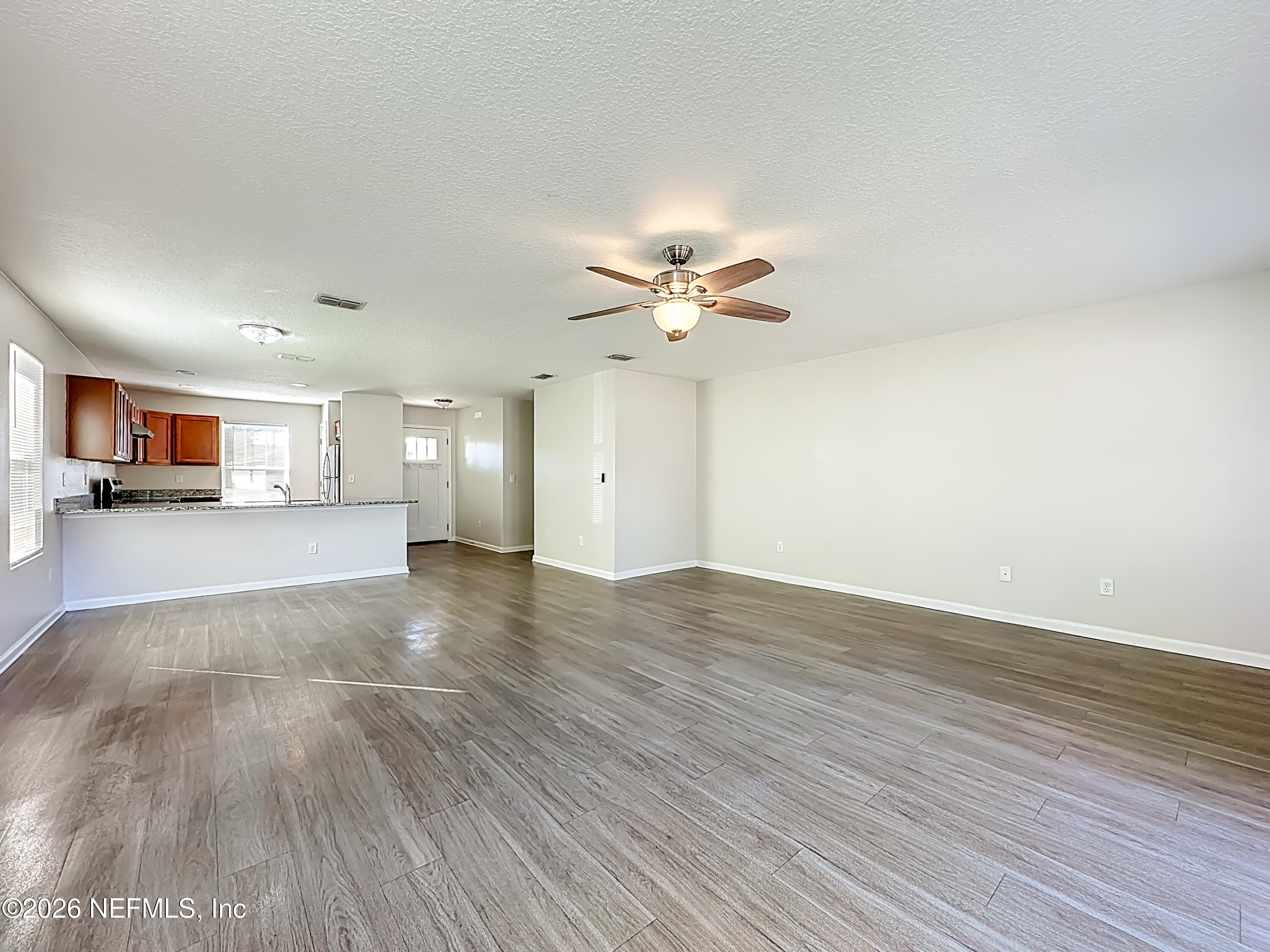 9487 Thorn Glen Road Jacksonville, FL 32208 - Photo 7 of 19 a view of a livingroom with a furniture wooden floor and a ceiling fan
