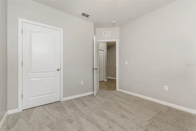 an empty room with closet area