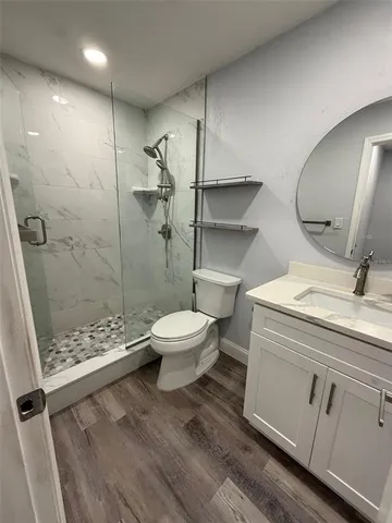a bathroom with a toilet a sink and shower
